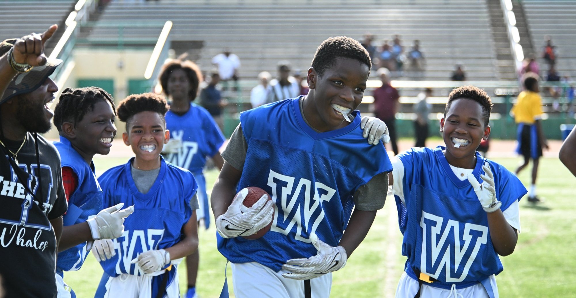 Players running drills at a training camp
